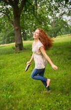 Young woman running in park.