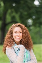 Portrait of young woman in park.