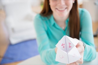 Teenage girl (14-15) showing origami