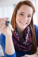 Portrait of teenage girl (14-15) holding car key