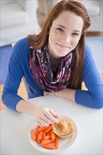 Portrait of teenage girl (14-15) with healthy snacks