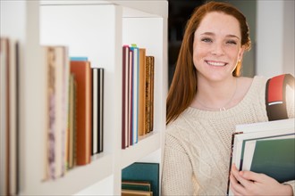 Teenage girl (14-15) with books