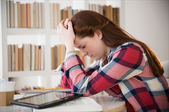 Teenage girl (14-15) tired of studying