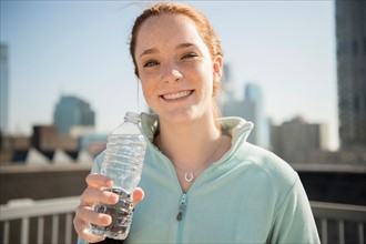 Teenage girl (14-15) with bottle of water