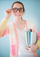 Teenage girl (14-15) in nerd glasses, studio shot