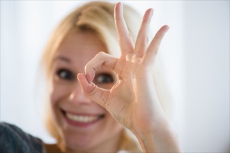 Young woman showing ok sign