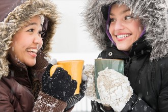 Two young women drinking hot chocolate
