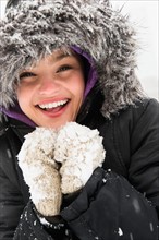 Portrait of smiling woman in warm clothing at winter