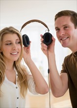 Couple using one headset together