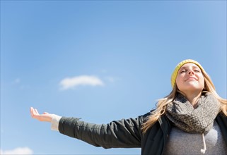 Young woman under blue sky
