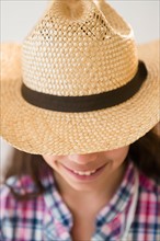 Girl (8-9) wearing straw hat