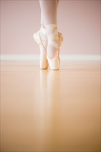 Low section of ballet dancer (16-17) tiptoing