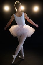 Rear view of teenage (16-17) ballerina on stage