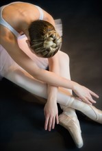 Teenage (16-17) ballerina bending over