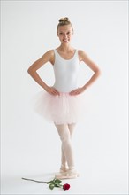 Teenage (16-17) ballet dancer with red rose