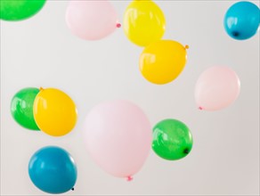 Studio Shot of colorful balloons falling down