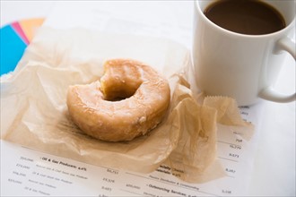 Studio Shot coffee and donut on documents