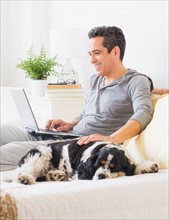 View of mature man using laptop at home