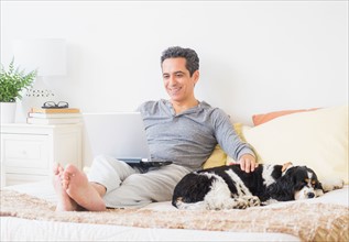 View of mature man using laptop at home