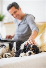 View of mature man petting dog