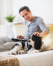 View of mature man petting dog