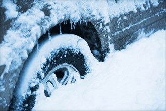 Car tire covered by snow, Close-up