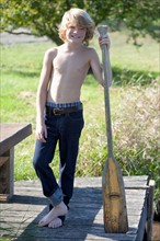 Boy (10-11) with oar