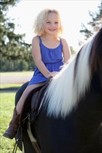 Girl (4-5) horseriding