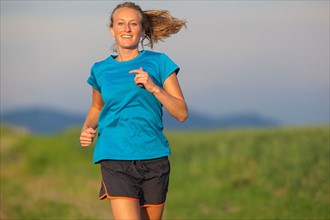 Front view of young woman jogging
