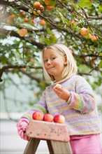 Girl (2-3) tasting apple