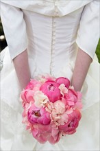 Bride with bouquet of pink flowers