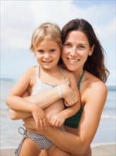 Mother with daughter (2-3) on beach