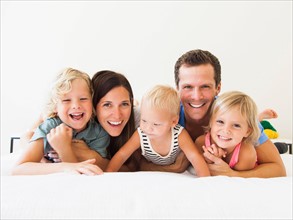 Portrait of family with three kids (6-7, 2-3, 6-11 months)