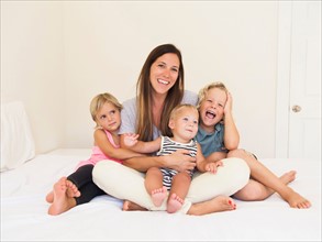 Mother with three kids (6-7, 2-3, 6-11 months)