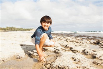 Boy (10-11) playing on beach