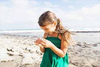 Girl (6-7) playing on beach