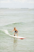 Boy (6-7) surfing