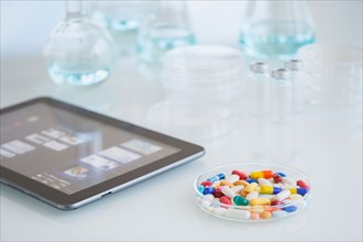 Studio shot of tablet pc and colorful pills.