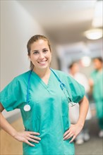 Portrait of female doctor in hospital hallway.