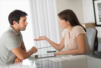 Man and woman talking in office.