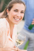 Portrait of woman drinking white wine.