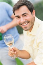 Portrait of man drinking white wine.