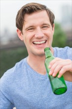 Portrait of man drinking beer.