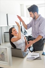 Woman and man giving high five to each other.