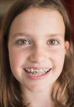 Girl (8-9) showing braces.
