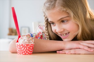 Portrait of girl (8-9) looking at ice cream