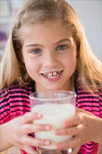 Portrait of girl (8-9) with glass of milk