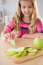 Portrait of girl (8-9) eating apple