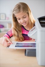 View of girl (8-9) printing photo