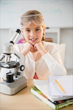 Portrait of girl (8-9) with microscope